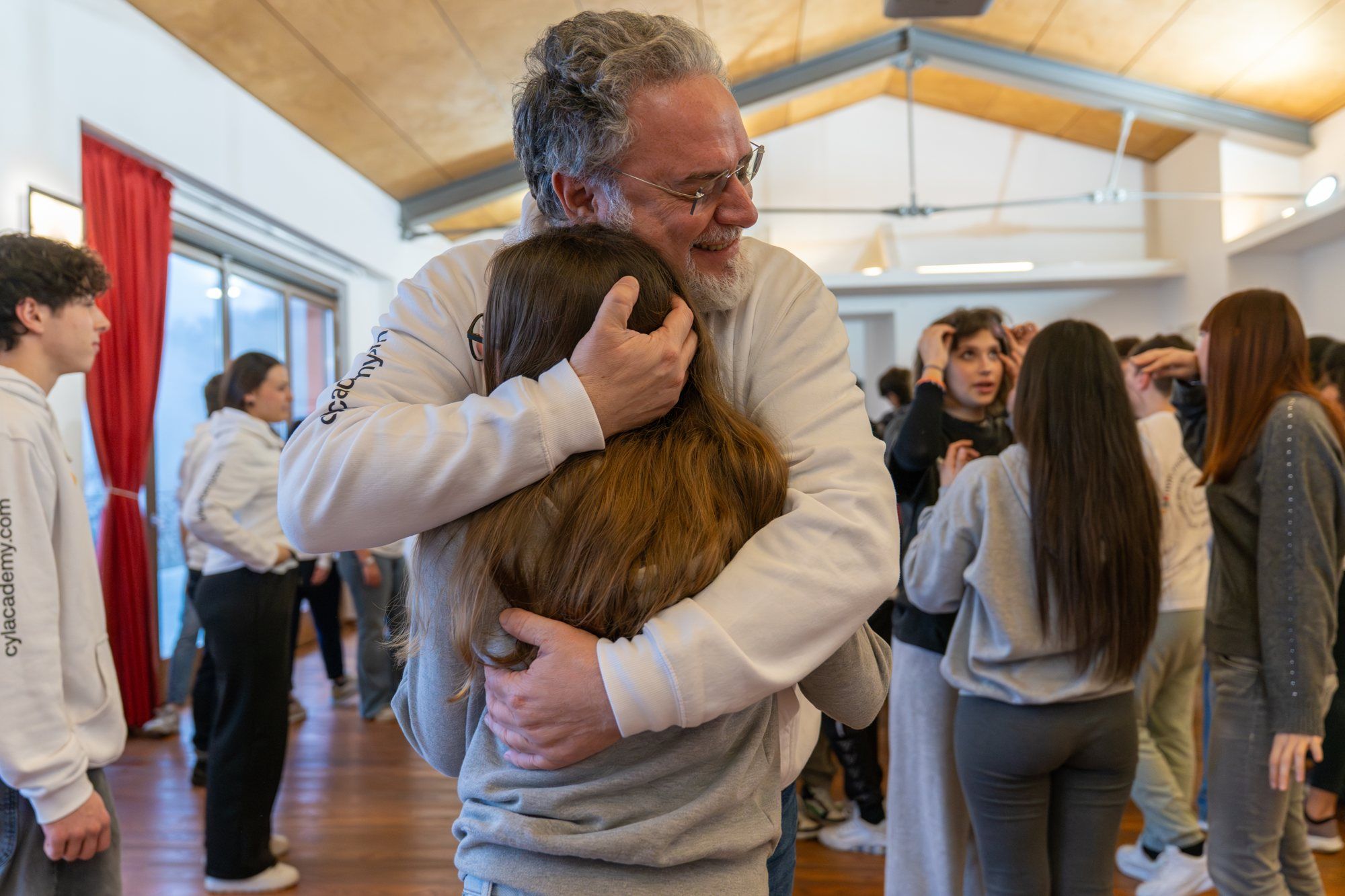 Filippo hugs a girl during a Change Your Life experience
